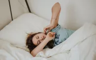 Woman Stretching While Laying in Bed